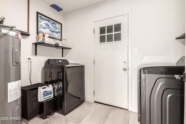 washroom with independent washer and dryer, water heater, and light tile patterned flooring