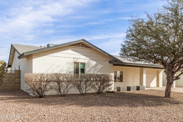 rear view of property with a garage