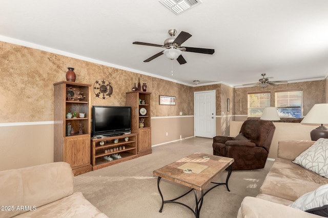 living room with light colored carpet, a ceiling fan, visible vents, ornamental molding, and wallpapered walls