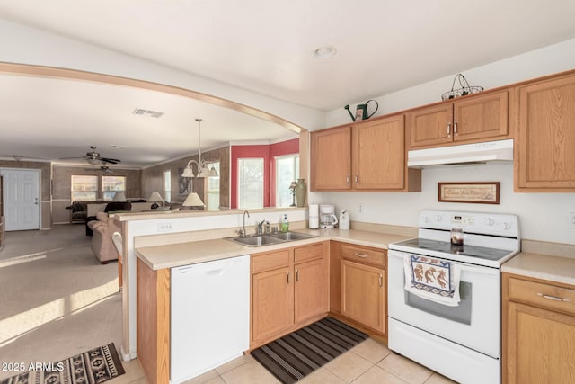 kitchen with white appliances, light countertops, under cabinet range hood, and a peninsula