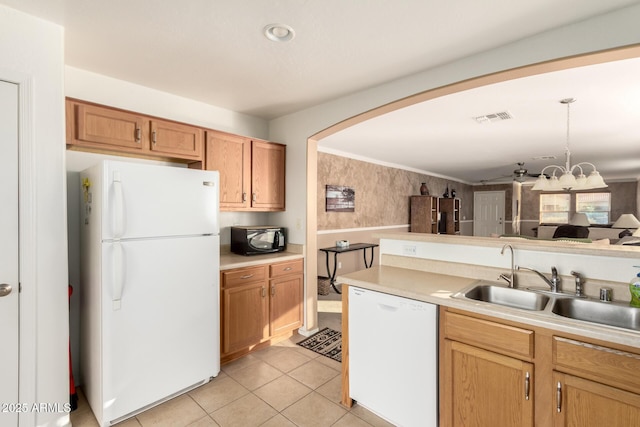 kitchen featuring white appliances, light tile patterned floors, visible vents, light countertops, and a sink