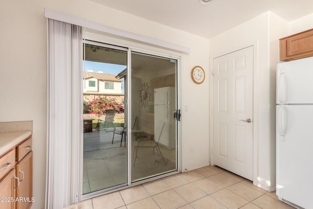 entryway with light tile patterned floors