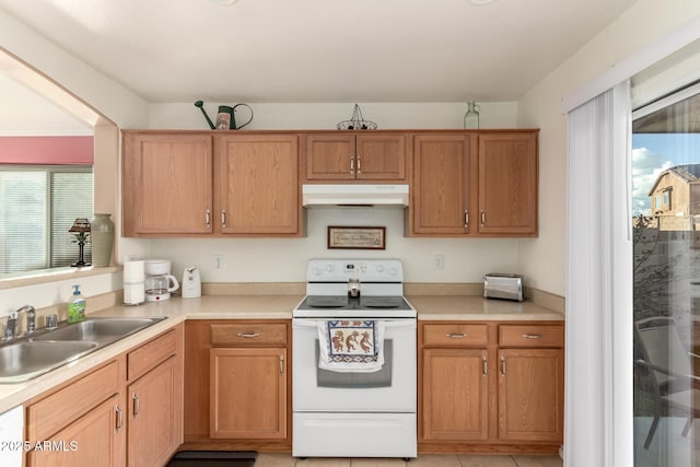 kitchen featuring light countertops, white range with electric stovetop, and under cabinet range hood