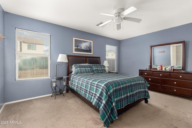 bedroom with light carpet, baseboards, visible vents, and a ceiling fan