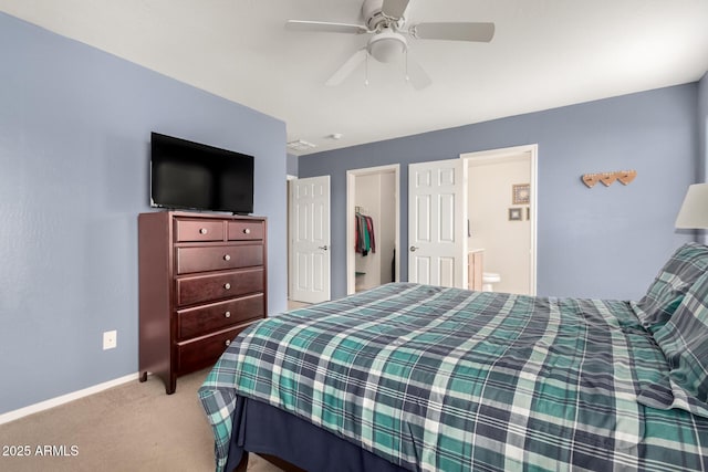 carpeted bedroom featuring ceiling fan, a closet, baseboards, and connected bathroom