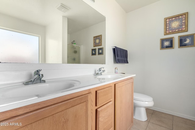 bathroom with a stall shower, a sink, visible vents, and tile patterned floors