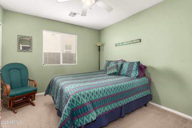 carpeted bedroom with baseboards, visible vents, and ceiling fan