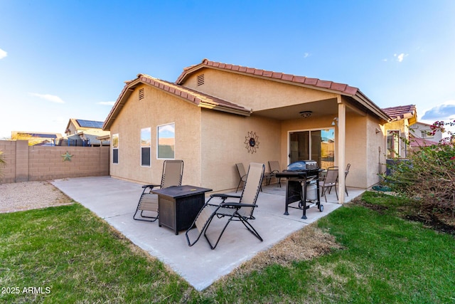 back of property with a patio, a lawn, a fenced backyard, and stucco siding