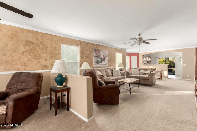 living area featuring ornamental molding, light carpet, and baseboards