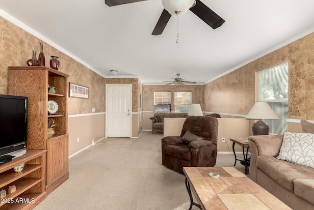 living area featuring a wealth of natural light, light carpet, and crown molding