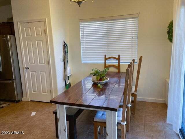 dining area featuring an inviting chandelier and light tile patterned floors