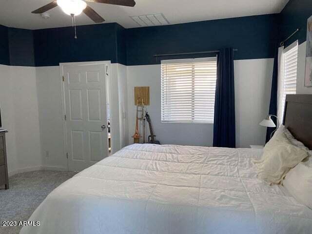 carpeted bedroom featuring ceiling fan