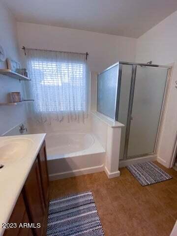 bathroom featuring vanity and plus walk in shower