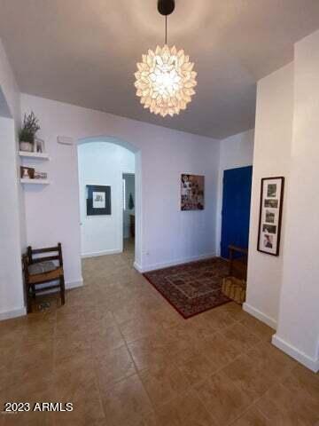 unfurnished dining area with a notable chandelier