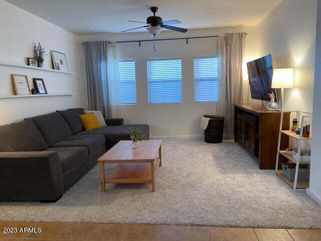 tiled living room featuring ceiling fan