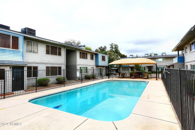 view of swimming pool featuring a patio area and central AC unit