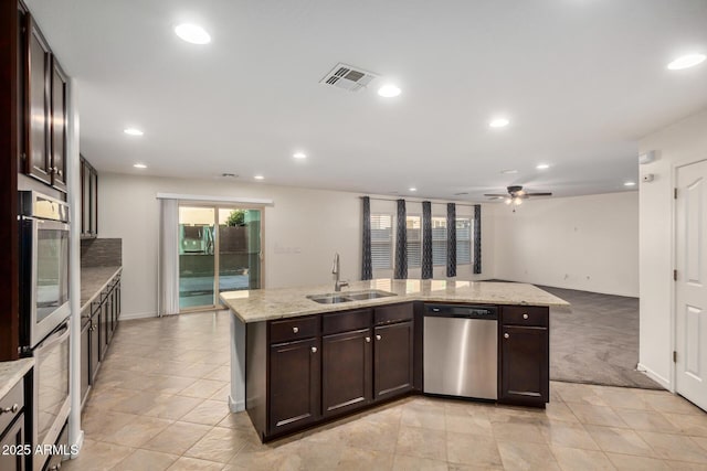 kitchen featuring recessed lighting, stainless steel appliances, a sink, visible vents, and dark brown cabinets