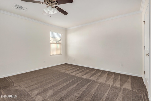 spare room featuring carpet floors, ornamental molding, visible vents, and baseboards