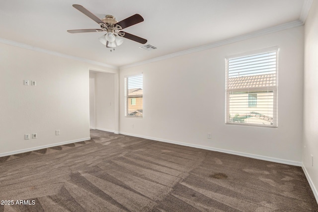 spare room with a healthy amount of sunlight, visible vents, and crown molding