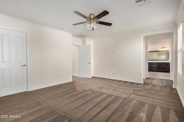 unfurnished bedroom featuring carpet floors, baseboards, visible vents, and ornamental molding