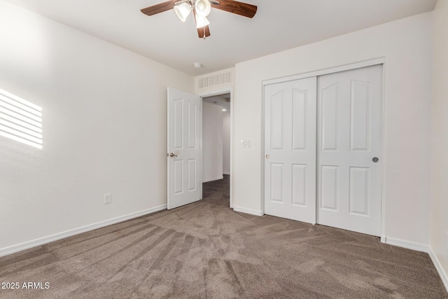 unfurnished bedroom with carpet floors, a closet, visible vents, and baseboards