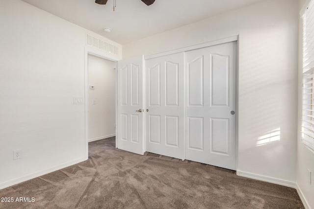 unfurnished bedroom featuring a closet, carpet flooring, ceiling fan, and baseboards