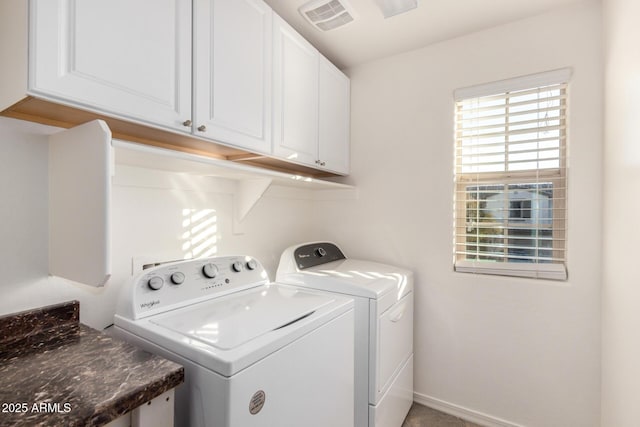 washroom with washer and clothes dryer, cabinet space, visible vents, and baseboards