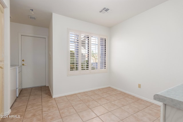 unfurnished dining area with light tile patterned floors