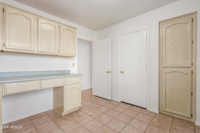 kitchen featuring built in desk and light tile patterned floors