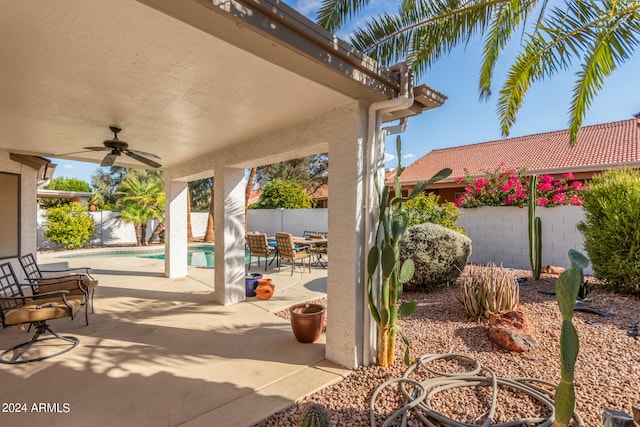 view of patio featuring a fenced in pool and ceiling fan