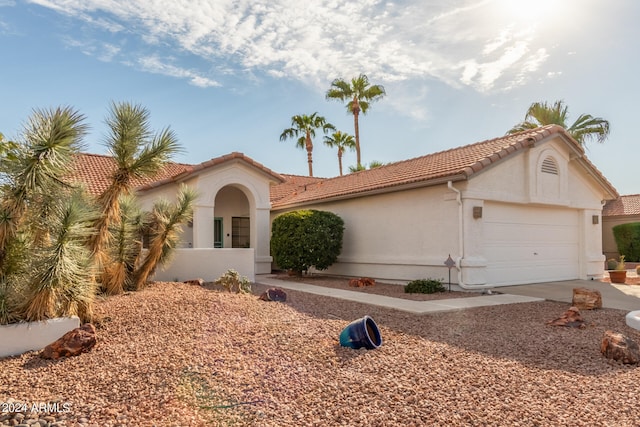 mediterranean / spanish-style home featuring a garage