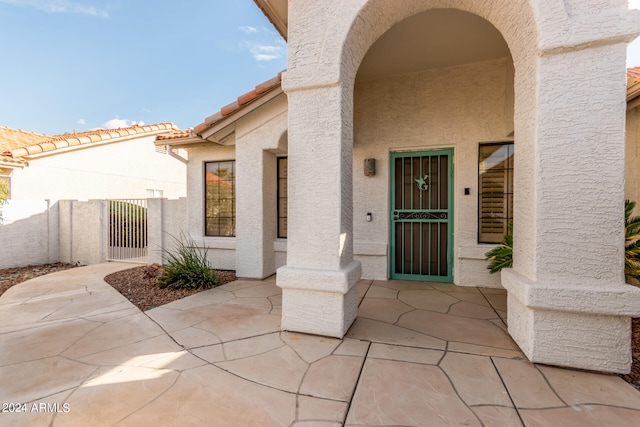 entrance to property with a patio