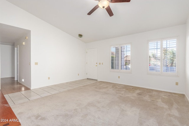 carpeted empty room with ceiling fan and lofted ceiling