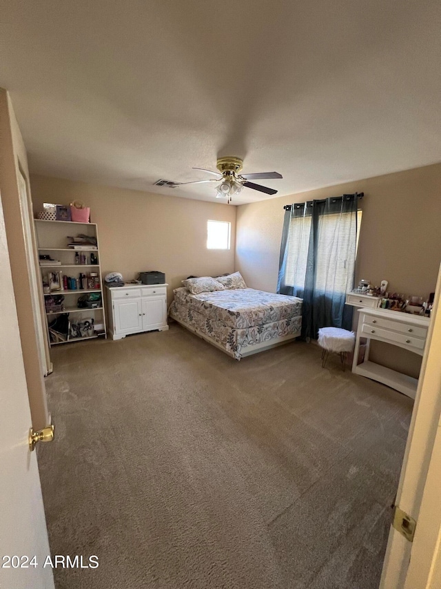 bedroom with ceiling fan and carpet flooring