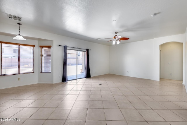 empty room featuring ceiling fan and light tile patterned flooring