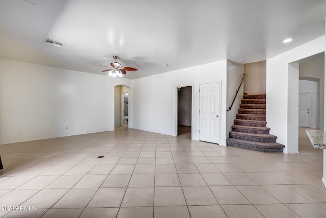 unfurnished living room with light tile patterned floors and ceiling fan