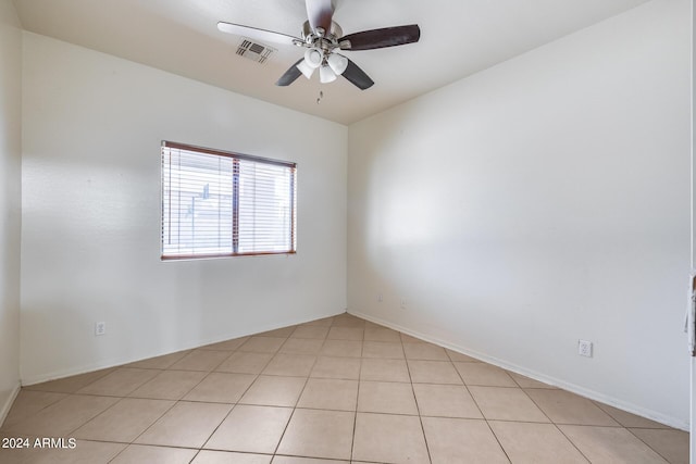 spare room featuring ceiling fan and light tile patterned flooring