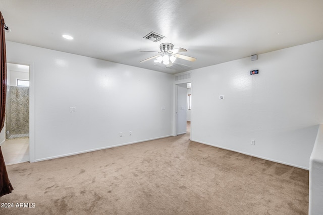 unfurnished room featuring ceiling fan and light colored carpet