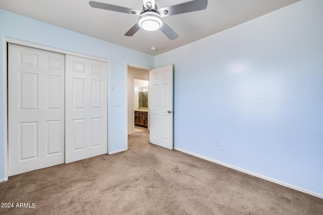 unfurnished bedroom featuring a closet, ceiling fan, and light colored carpet