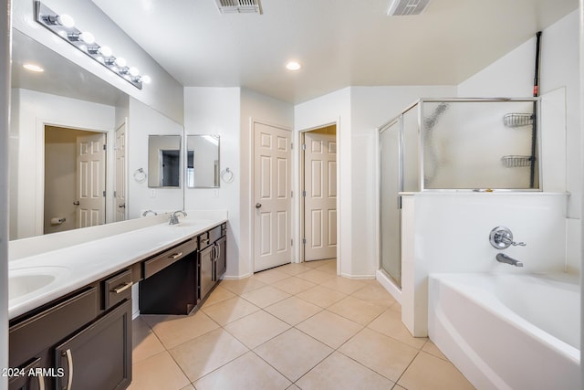 bathroom featuring vanity, plus walk in shower, and tile patterned flooring