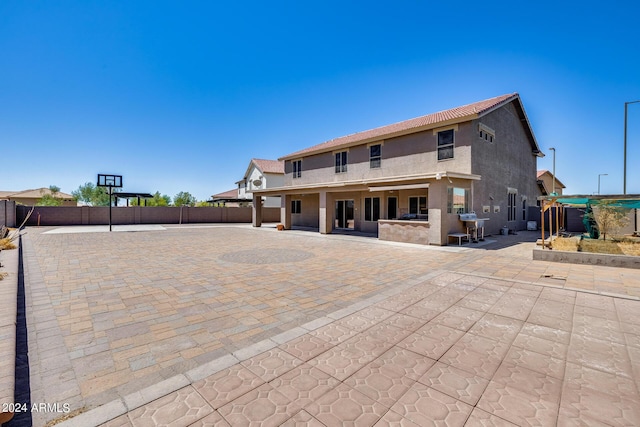 back of property featuring a patio area