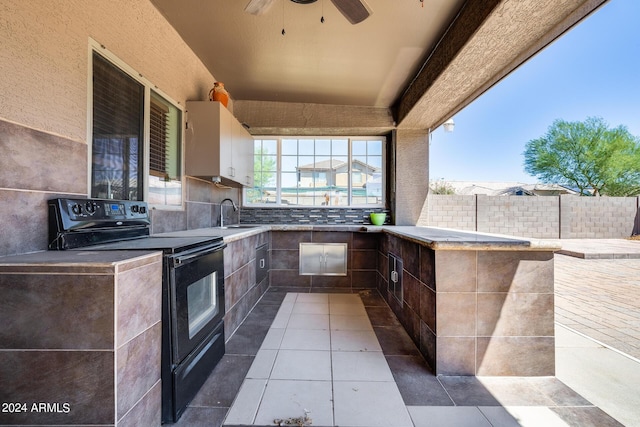 view of patio featuring sink, ceiling fan, and area for grilling