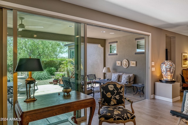 interior space with hardwood / wood-style flooring, ceiling fan, and a healthy amount of sunlight