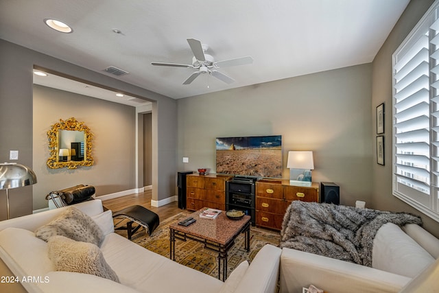 living room with hardwood / wood-style flooring and ceiling fan