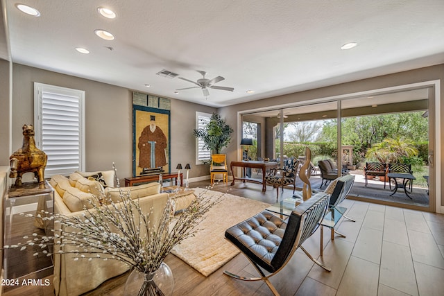 living room with plenty of natural light and ceiling fan