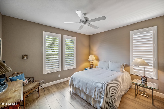 bedroom featuring ceiling fan and light hardwood / wood-style flooring