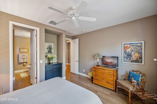 bedroom featuring light wood-type flooring, ensuite bath, and ceiling fan