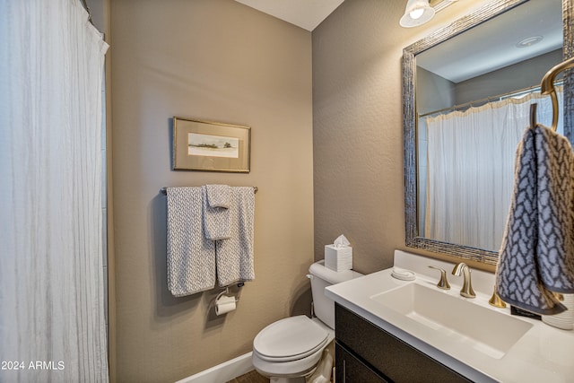 bathroom featuring vanity, toilet, and a shower with shower curtain