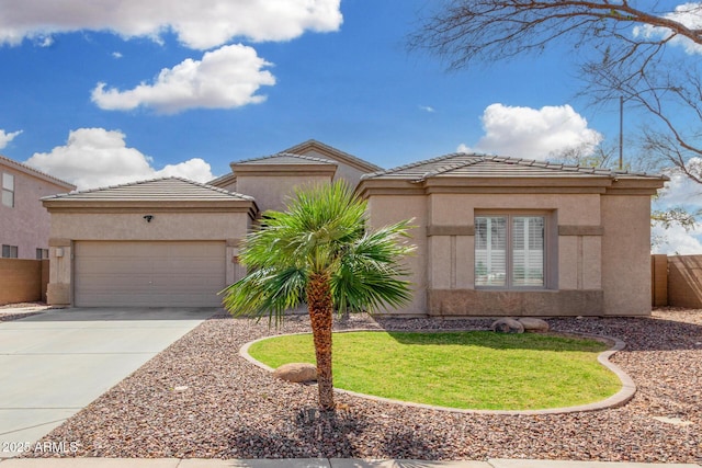 view of front of property with a garage, driveway, fence, and stucco siding