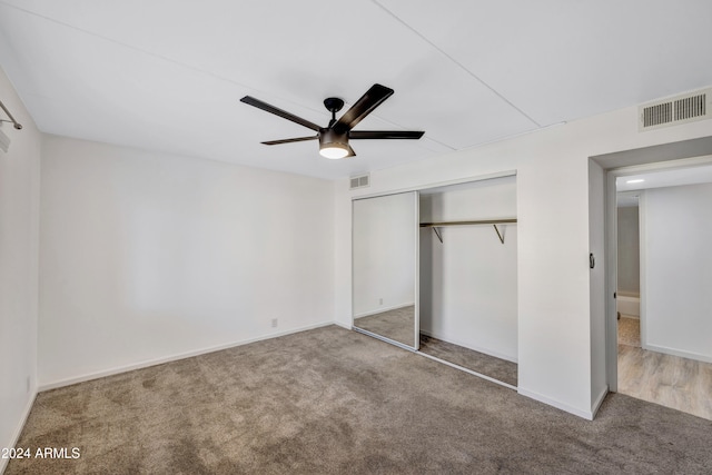 unfurnished bedroom with a closet, ceiling fan, and carpet flooring